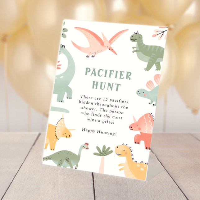 Dinosaur Pacifier Sign (Dinosaur Table Top Baby Shower Pacifier Hunt Pedestal Sign by Painted Paperie
)