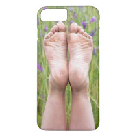 dirty bare feet in wildflowers