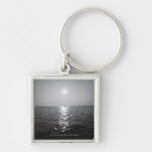 Distant boat on ocean key ring