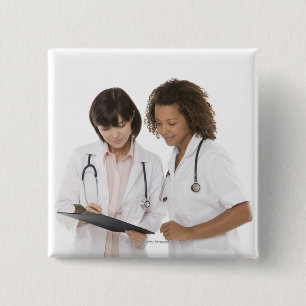 Doctors looking at clipboard 15 cm square badge
