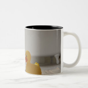 Dog on mat with plastic duck Two-Tone coffee mug