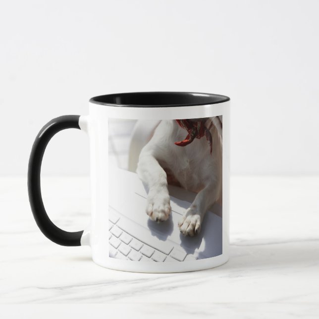 Dog putting his hands on a laptop mug (Left)