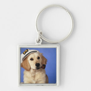 Dog wearing cap, holding smoke pipe key ring