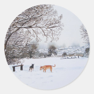 dogs playing in snowy landscape scenic christmas classic round sticker