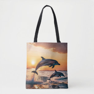 Dolphins at sunset tote bag