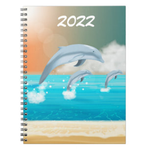 dolphins breaching in the ocean notebook