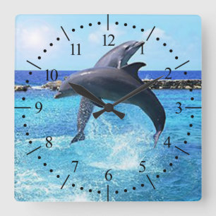 Dolphins dancing in the ocean square wall clock