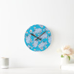 Dr. Seuss Horton Hears a Who Round Clock<br><div class="desc">This pattern design features characters from the classic Dr. Seuss story, Horton Hears a Who!. Multiple illustrations of Horton the elephant are scattered across a solid cyan blue background. He is depicted alongside numerous white and pink daisies. The style utilises the signature sketchy, hand-drawn lines associated with Dr. Seuss illustrations....</div>