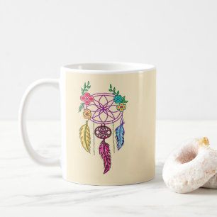 Dreamcatcher and flower held in hand coffee mug