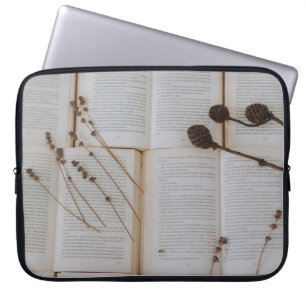 Dried flowers on books laptop sleeve