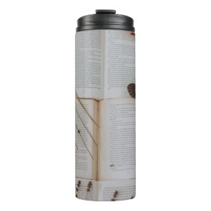 Dried flowers on books thermal tumbler