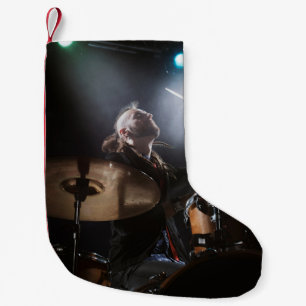 Drummer silhouette, dark stage setting small christmas stocking