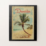 Dunedin Palm Tree Vintage Travel Jigsaw Puzzle<br><div class="desc">A uniquely retro mid-century modern Dunedin Florida art print in vintage travel poster style. It features a curved palm tree on sandy beach with ocean under a blue cloudy sky.</div>