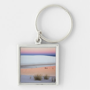 Dusk sky reflected in pool of water from key ring