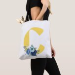Dusty Blue Floral Monogram Yellow Initial Birthday Tote Bag<br><div class="desc">This stylish and practical tote bag features a large, sunny yellow monogram "C" accented with a beautiful cluster of dusty blue and navy watercolor flowers. Perfect for carrying books, groceries, or daily essentials, this botanical design combines bold typography with soft floral details. It makes a thoughtful personalized gift for birthdays,...</div>