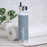 Dusty Blue Personalised Wedding Bridesmaid Water Bottle<br><div class="desc">Gift your wedding bridesmaid or maid of honour with this trendy, vacuum Insulated water bottle that features her name in white, stylised script on a dusty blue colour background designed to match your wedding colour scheme. Personalise bottle by editing and replacing name with your own as desired. Select your water...</div>