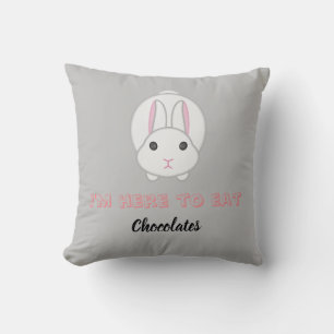 Easter bunny waiting to eat chocolates thr cushion