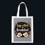 Egg-cited for Breakfast Funny Foodie Pun Design Reusable Grocery Bag<br><div class="desc">Start your morning with a smile with this playful "Egg-cited for Breakfast" design, perfect for food lovers and brunch enthusiasts alike. Featuring a charming hand-drawn style, this artwork showcases two sunny-side-up eggs alongside crispy bacon strips, all set against a whimsical backdrop of scattered seasonings and vibrant typography. The warm yellow...</div>
