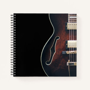 Electric Guitar On Black Notebook