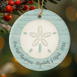 Elegant Beach Sand Dollar Photo First Christmas Ceramic Ornament<br><div class="desc">A joyful Christmas ornament with a sand dollar and a weathered wood background for your 1st Christmas Celebration. Great for newlyweds. Put a beach honeymoon photo on the back. Personalise the front with your names and the year. Designed for you by Blackberry Boulevard.</div>