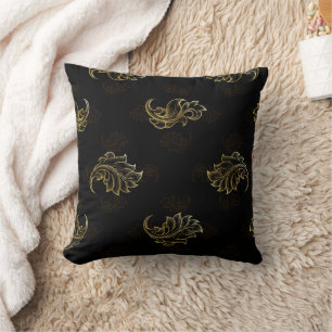 Elegant black background with intricate gold leaf cushion
