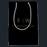 Elegant Black Gold Minimalist Monogram Name Medium Gift Bag<br><div class="desc">Present your gifts in style with our Black and Gold Modern Minimalist Monogram Name Gift Bag. This elegant bag boasts a clean and contemporary design, featuring a customisable monogram that adds a personalised touch to your gift-giving. Crafted with quality in mind, this bag is both sophisticated and minimalist, making it...</div>