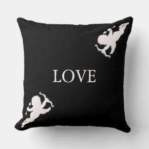 Elegant cupids in white on black cushion