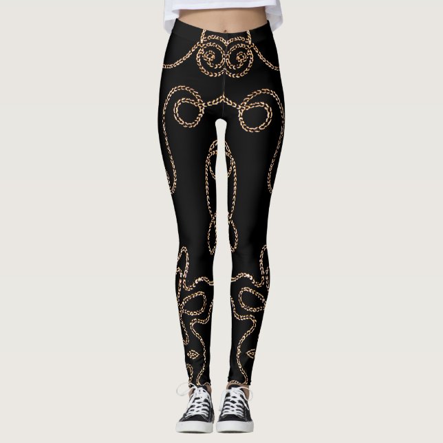 Elegant gold embellishments on black leggings (Front)