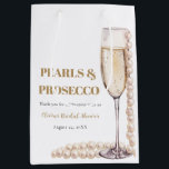 Elegant Gold Pearls and Prosecco Bridal Shower Medium Gift Bag<br><div class="desc">Indulge in the epitome of bridal elegance with our Elegant Gold Pearls and Prosecco Bridal Shower Large Gift Bag. Featuring a luxurious blend of shimmering gold tones and delicate pearl accents, this bag exudes sophistication. The subtle imagery of sparkling prosecco adds a touch of celebration to the occasion. Spacious and...</div>