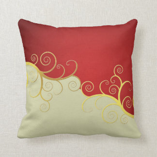 Elegant golden swirls on red and cream cushion