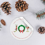 Elegant joy Christmas wreath family address  Classic Round Sticker<br><div class="desc">Simple elegant family or business Christmas holiday sticker featuring JOY floral typography script with retro traditional fir branches wreath,  holly berries,  and a red bow.              Personalise it with your name and text!</div>