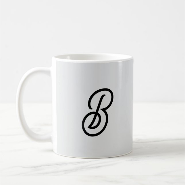 Elegant minimalist modern initial on grey coffee mug (Left)