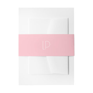 Elegant minimalist modern initial on pastel pink invitation belly band