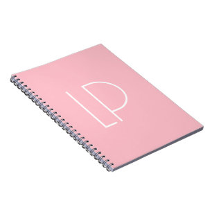 Elegant minimalist modern initial on pastel pink notebook