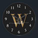 Elegant Modern Black Gold Monogram Name Script Large Clock<br><div class="desc">Girly Modern Elegant Stylish Black and Gold Monogram Initial Name Script Custom Personalised Large Clock. This design featuring a first name in a pretty hand lettered swash tail font calligraphy (or typography) with monogram initial in gold and white on black. Easy to customise it. Great stylish feminine housewarming gift, also...</div>