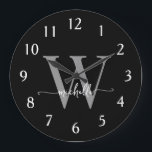 Elegant Modern Black Grey Monogram Name Script Large Clock<br><div class="desc">Girly Modern Elegant Stylish Black and Grey Monogram Initial Name Script Custom Personalised Large Clock. This design featuring a first name in a pretty hand lettered swash tail font calligraphy (or typography) with monogram initial in grey and white on black. Easy to customise it. Great stylish feminine housewarming gift, also...</div>