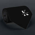 Elegant Monogram | Black White Tie<br><div class="desc">An elegant necktie featuring a bold white monogram across a black background. Atop this monogram sits your first or last name spelled out in all capitals. If you prefer a bolder look for the personal name inside of the large letter you can do the following: Use the customize/ edit function...</div>
