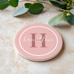 Elegant Pink Round Custom Monogram Initial Coaster<br><div class="desc">Elegant round personalised beverage drink coaster design features a classic custom serif monogram initial in a rosewood colour with your last name in modern white calligraphy script against a pretty blush pink / rose gold coloured background. A simple white circle frames the design. Colour scheme can be customised to coordinate...</div>