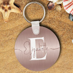 Elegant Rose Gold Brushed Metal Girly Monogrammed Key Ring<br><div class="desc">Elevate your everyday essentials with our Elegant Rose Gold Brushed Metal Girly Monogrammed Keychain! Personalise this stylish accessory with your monogram elegantly presented in white on a chic rose gold brushed metal pendant. Whether for keys or a fashionable addition to your bags, this keychain adds a touch of sophistication to...</div>