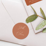 Elegant Rustic Terracotta Calligraphy Wedding Classic Round Sticker<br><div class="desc">Elegant white script calligraphy of bride and grooms name on rustic terracotta round sticker.</div>