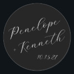 Elegant Script Calligraphy Wedding Custom Black Classic Round Sticker<br><div class="desc">Add a touch of timeless elegance to your wedding with these custom round stickers featuring beautiful script calligraphy. The sleek black background creates a striking contrast with the crisp white lettering, offering a chic and sophisticated look. Perfect for sealing envelopes, decorating favours, or adding a personalised touch to your wedding...</div>