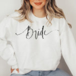 Elegant Script Modern Bride Sweatshirt<br><div class="desc">This is an elegant "bride" sweatshirt featuring a beautiful calligraphy font. All colours are editable, but the wording is not editable // For matching items, please visit the "BRIDE" collection in the By Nicole Designs Zazzle store. * If you like this design but don't see it available for something you...</div>