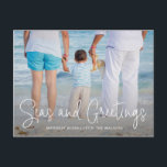 Elegant Seas and Greetings Beach Photo Christmas Holiday Postcard<br><div class="desc">Send out holiday cheer with this nautical themed Christmas postcard featuring a simple design with the words "Seas and Greetings" in an elegant thin white script,  along with your message over your favourite horizontal beach vacation photo.  The backside has your personal message and your return address for easy mailing.</div>