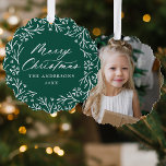 Elegant Snowflake Wreath Green Photo Christmas Tree Decoration Card<br><div class="desc">Elegant holiday photo ornament card featuring "Merry Christmas" displayed in a white calligraphy script encircled by a wreath of snowflakes and pine branches on a dark green background. Personalise the front of the ornament card by adding your family name and the year. The back of the paper ornament features your...</div>