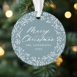 Elegant Snowflake Wreath Ice Blue Christmas Photo Ornament<br><div class="desc">Elegant holiday photo ornament featuring "Merry Christmas" displayed in a white calligraphy script encircled by a wreath of snowflakes and pine branches on a frosted blue background. Personalise the front of the ornament by adding your family name and the year. The back of the ornament features your favourite family photo...</div>