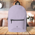 Elegant Sophisticated Classic Monogram Lilac Printed Backpack<br><div class="desc">An elegant mininalist design with a classic typography initial and name in black on a pastel lilac lavender purple background. The perfect personalised accessory which is easy to customise for any occasion!</div>