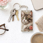 Elegant Tabby Cat  Key Ring<br><div class="desc">Show off your love for cats with this stunning, artfully detailed key chain featuring a majestic long-haired feline with striking green eyes. Set against a soft, neutral background with a subtle floral accent, this design blends realism with a touch of elegance. The warm tones and intricate fur detailing create a...</div>