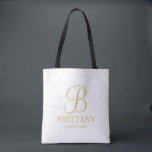 Elegant White and Gold Personalised Bridesmaid Tote Bag<br><div class="desc">Elegant Personalised Bridesmaid Gifts featuring personalised monogram in gold elegant script font style with bridesmaid's name and title in gold classic serif font style. Also perfect for Maid of Honour, Flower Girl, Mother of the Bride and more. Please Note: The foil details are simulated in the artwork. No actual foil...</div>