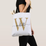 Elegant White Gold Girly Personalised Monogrammed Tote Bag<br><div class="desc">Girly Modern Simple Elegant White and Gold Monogram Initial Name Signature Script Custom Personalised Tote Bag. This design featuring your first name in a pretty hand lettered style swash tail font typography (or calligraphy) with monogram initial in gold and black on white colour background. Great feminine gift for birthday, wedding,...</div>