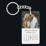 Elegant White Photo Wedding Anniversary Calendar Key Ring<br><div class="desc">Give a truly personalised wedding anniversary gift with these elegant custom calendar keychain. The front design features a simple, modern black and white calendar which can be easily personalised with the names of the couple, monogram and the wedding date. And don't forget to move the heart to surround the wedding...</div>